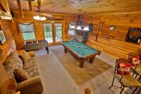 Game Area of Smoky Trails with pool table, foosball, dartboard and sleeper sofa